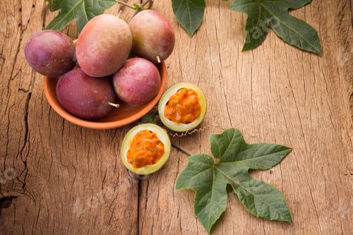 Preview: fruits of gulupa on vine wood table, Passiflora pinnatistipula