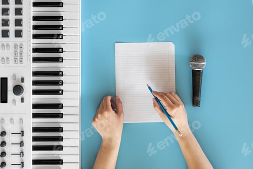 Preview: Musical keys, microphone and blank paper on a blue background.