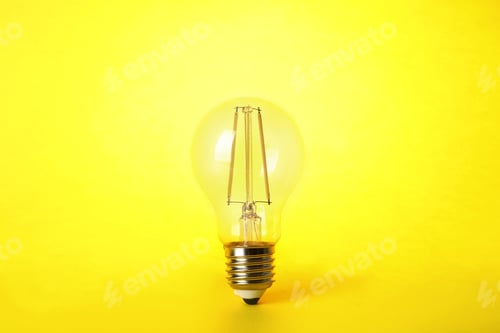 Preview: Vintage filament lamp bulb on yellow background