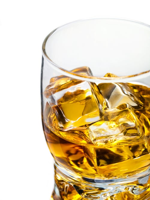 Golden Liquor with Ice Cubes in Glass