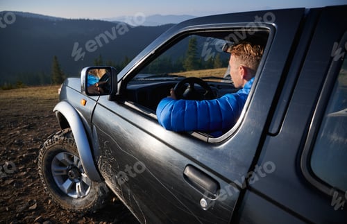 Preview: Off-road riding on black SUV in the mountains.