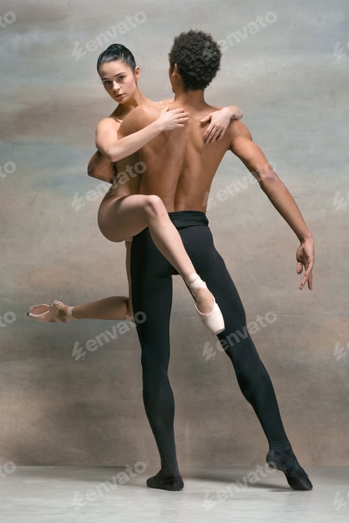 Preview: Couple of ballet dancers posing over gray background