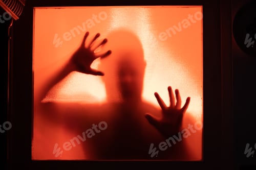 Vista previa: Shadowy figure, man behind glass - horror background