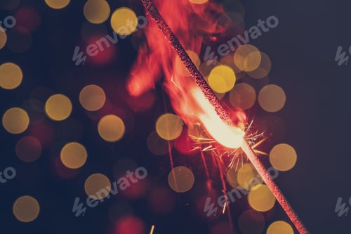 Preview: Red bengal sparkle lights close up on dark background