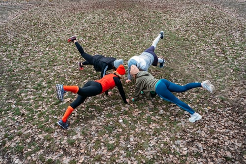 Preview: Group fitness classes outdoors. Organized gym classes set up in public parks. Three women and man