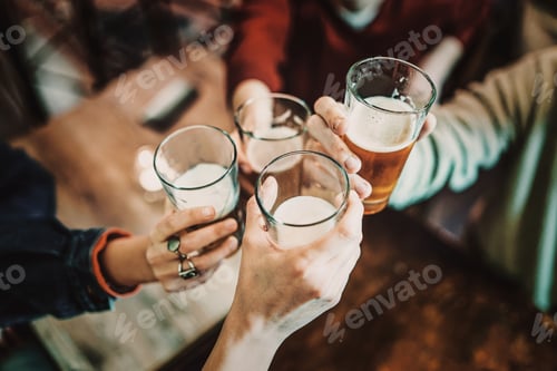 Preview: Celebratory toast with friends - Group cheers at bar