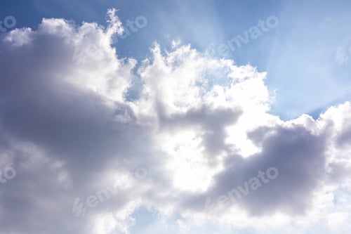 Preview: Beautiful dark cumulus clouds with sunlight. The direct rays of the sun shine through the clouds.