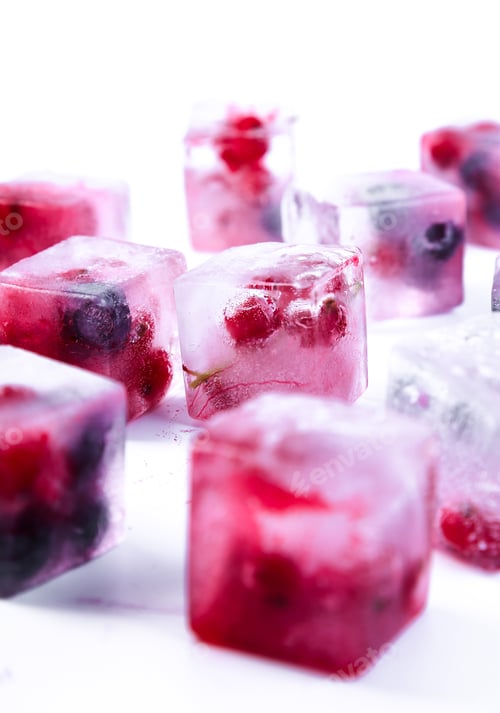 Frozen Delight: Berry Ice Cubes on White Surface