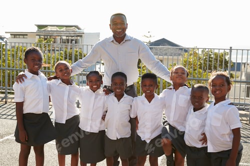 Preview: Teacher and elementary school kids in playground, portrait
