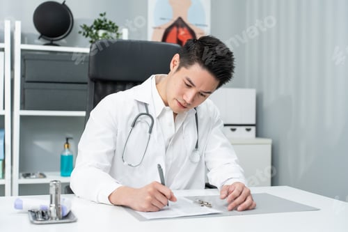 Preview: Asian specialist male doctor write note on table in office hospital.