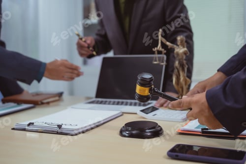Preview: Three lawyers in a meeting at the table in an office, discussing business,civil and commercial law