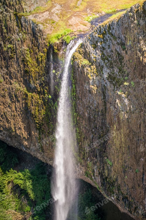 Preview: Waterfall dropping off over vertical basalt walls