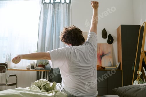 Preview: Stretching in Cozy Bedroom on Sunny Morning
