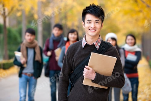 Preview: Male college student on campus with his friends in background