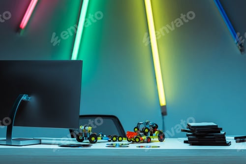 Preview: computer, toy cars and compact disks with video games on table