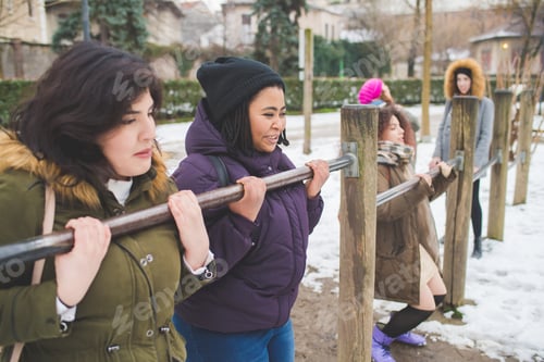 Preview: group of young multiracial women having fun in paly area outdoor