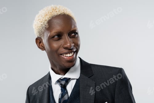 Preview: portrait of blonde african american man with blue eyes smiling isolated on grey