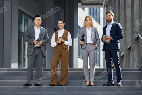 Preview: Professional business team taking a break outside office building