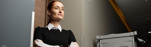 Preview: Confident young woman in stylish outfit standing near modern interior in bright light
