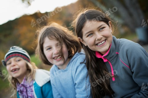 Preview: Three young girls, children, outside in the fresh air. Autumn foliage.