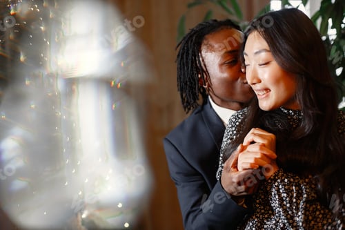 Preview: Happy couple celebrating their engagement in a cafe and hugging tightly