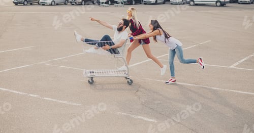 Preview: Young women pushing cart with male friend