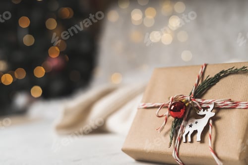 Preview: Gift with Ornament and Twine on White Table