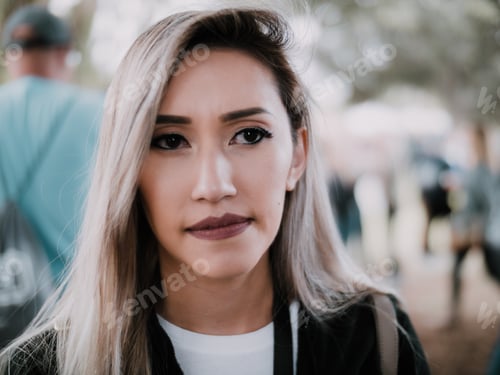 Preview: Young woman face portrait up close serious sad worried thinking looking outdoors public concerned