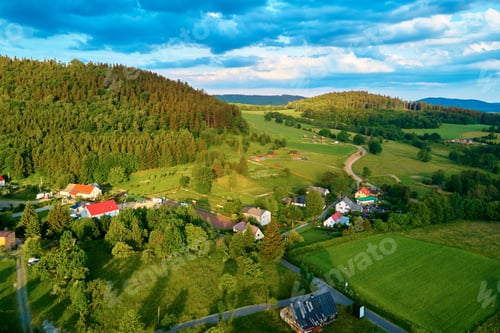 Preview: Aerial view of countryside area with village and mountains