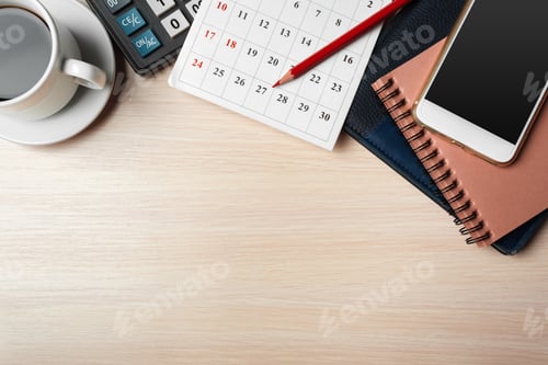Preview: Work desk setup with calendar, coffee, and smartphone in a bright office environment