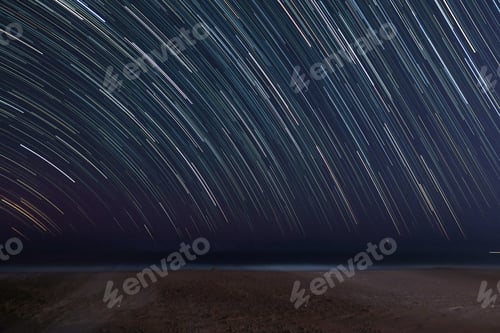 Preview: Star trail on beach background with space for text