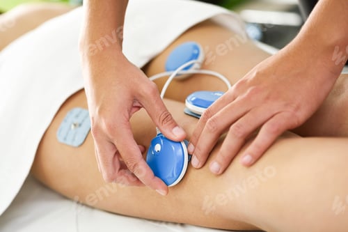 Preview: Physiotherapist applying electro stimulation in physical therapy