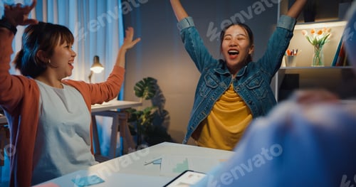 Preview: Multiracial group young asia creative people discussing business gesture hand high five.