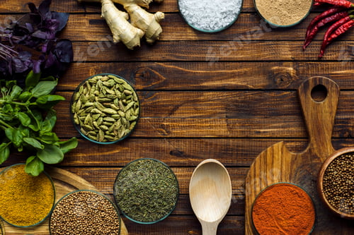 Preview: Top view of various spices on a wooden brown table