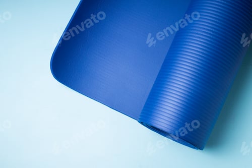 Preview: Unrolled Blue Yoga Mat on Light Blue Surface