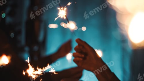 Preview: Silhouette of hands waving sparkles for new year event party