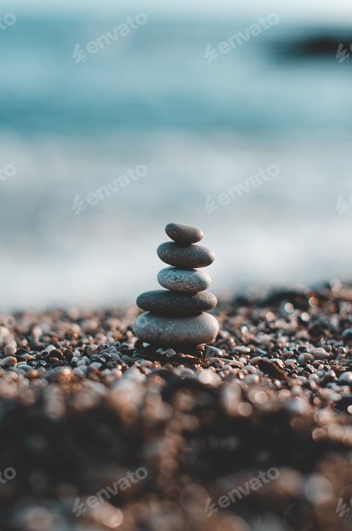 Preview: Vertical shot of a stack of pebbles on the beach