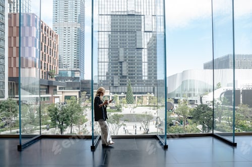 Preview: Professional woman working on her laptop in a dynamic cityscape