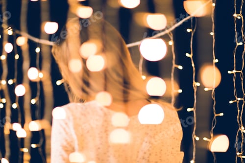 Preview: back view of woman with christmas light around on black