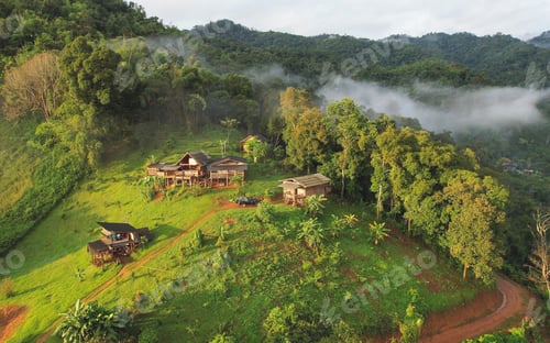 Preview: Aerial view from drone of the rural village in the mountains on foggy day