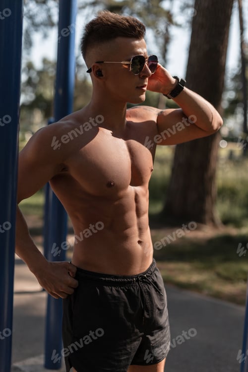 Preview: Cool handsome healthy muscular athletic man training outdoors