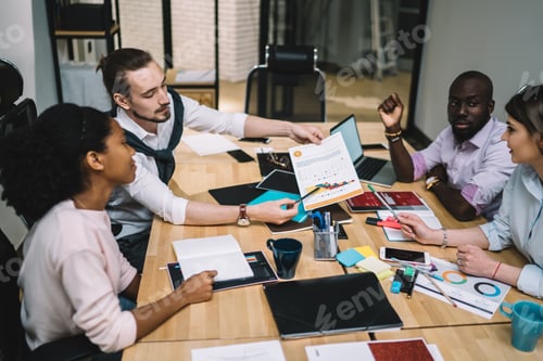 Preview: Creative multiethnic managers discussing while working together at office