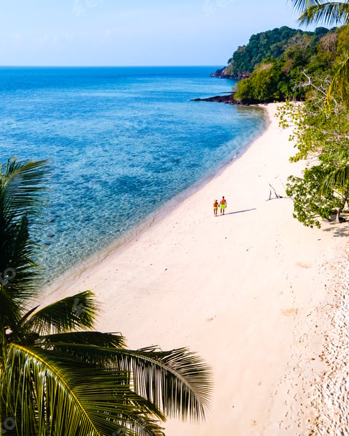 Preview: drone view at the beach of Koh Kradan island in Thailand couple men and woman walking on the beach