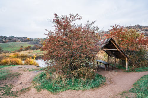 Preview: Small wooden gazebo among beautiful autumn trees on the Carpathian hills in Ukraine