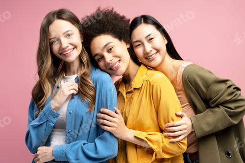 Preview: Three diverse women embracing and smiling on pink background