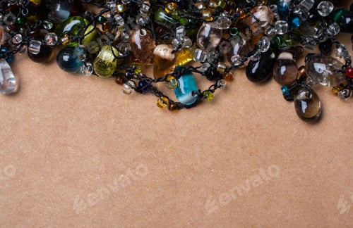 Preview: Closeup shot of colorful beads on a brown background