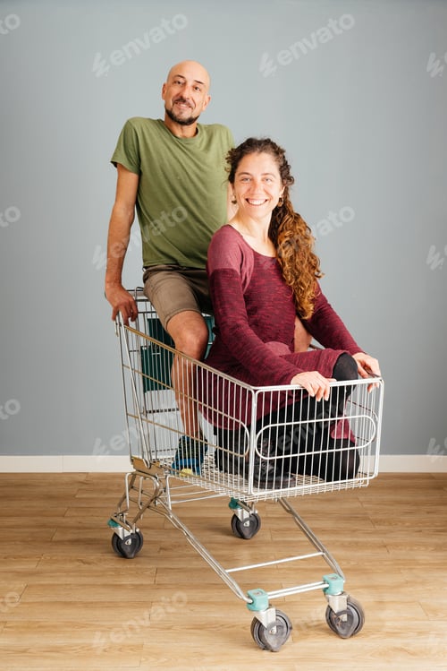 Preview: Happy Man and Woman Sitting in a Shopping Cart