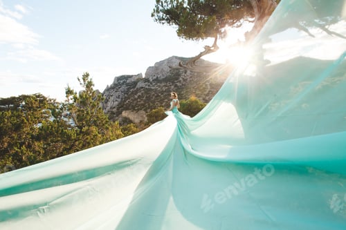 Preview: Bride in nature in the mountains near the water. Dress color Tiffany