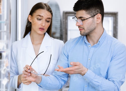 Preview: Optometrist helping man to choose new correction glasses