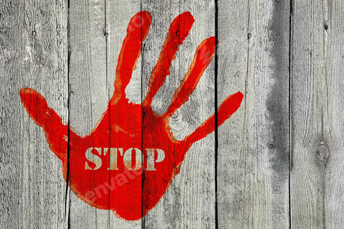 Preview: Handprint with the word ''Stop'' on old wooden fence background